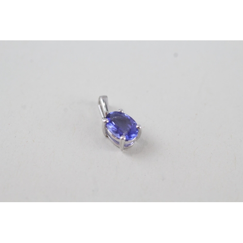 317 - 2x 9ct gold oval cut tanzanite pendant, claw set 1.1g