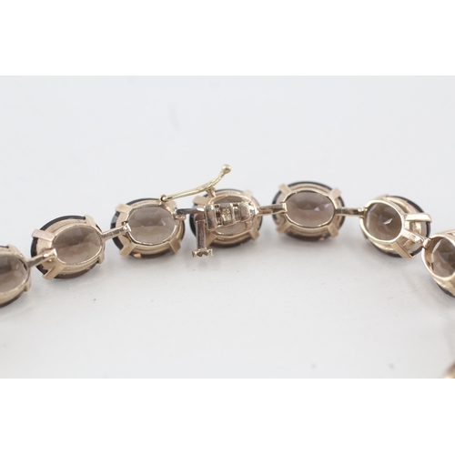 133 - 10ct gold oval cut smokey quartz bracelet 15g