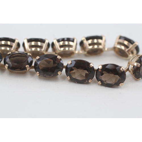 133 - 10ct gold oval cut smokey quartz bracelet 15g