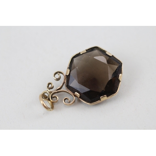 148 - 9ct gold smokey quartz pendant 3.1g