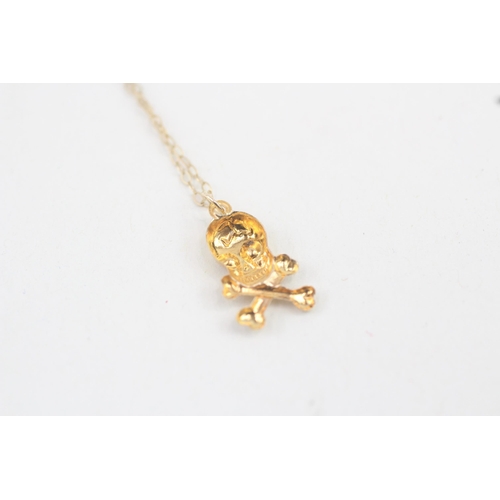 30 - 9ct gold skull and crossbones pendant with 9ct gold chain 0.6g