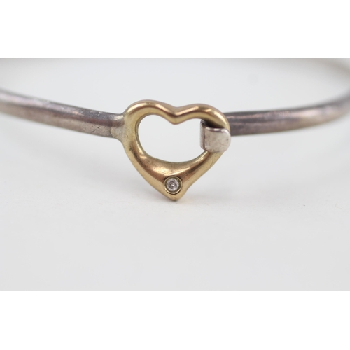 93 - 9ct gold and silver diamond heart bangle 9.6g