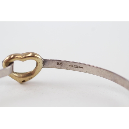 93 - 9ct gold and silver diamond heart bangle 9.6g