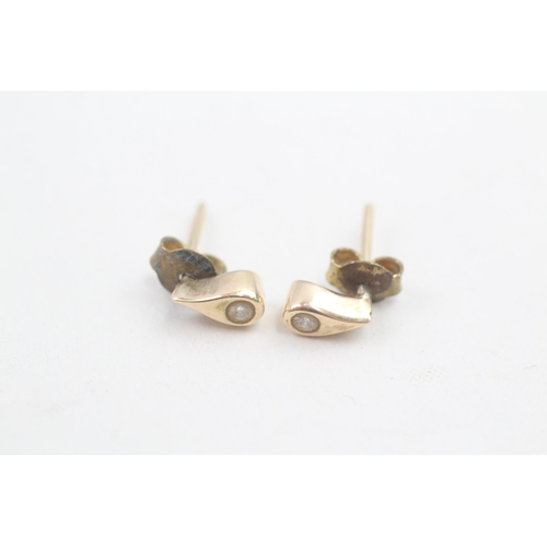 142 - 9ct gold diamond set teardrop stud earrings (1.2g)