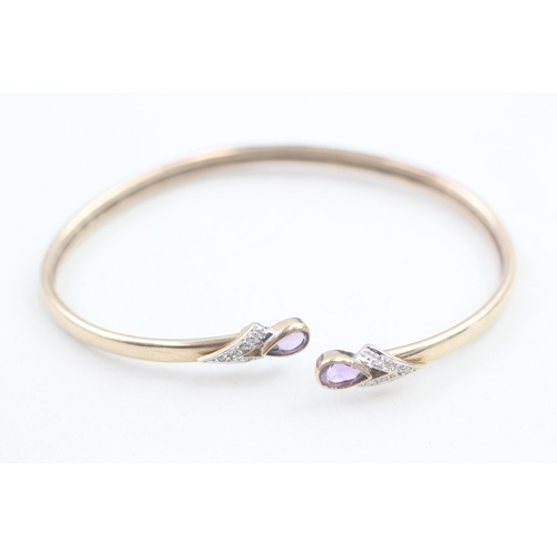 143 - 9ct gold diamond accented pear cut amethyst set cuff bangle (6.5g)