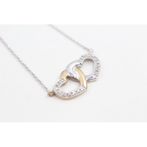 145 - 9ct white and yellow gold diamond set entwined heart static pendant necklace (2.1g)
