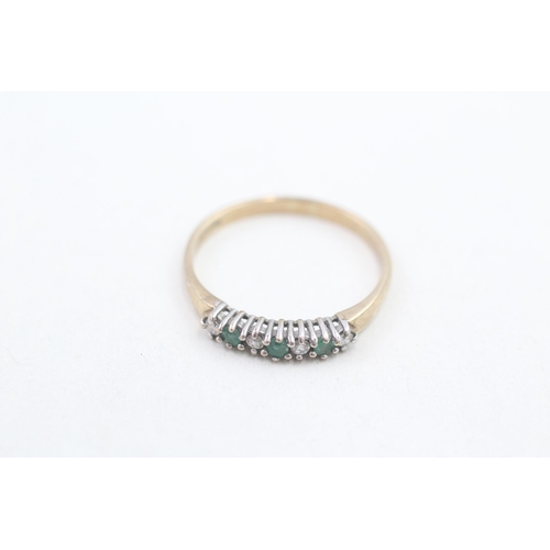 147 - 9ct gold diamond and emerald set seven stone eternity ring (1.7g) Size R