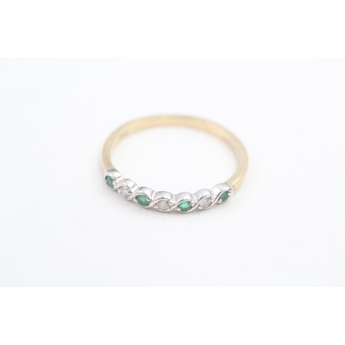 148 - 9ct gold diamond and emerald set seven stone eternity ring (1.8g) Size R