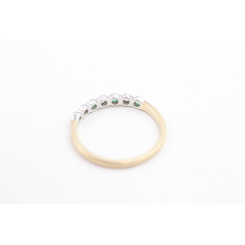 148 - 9ct gold diamond and emerald set seven stone eternity ring (1.8g) Size R