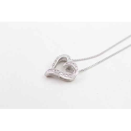 162 - 9ct white gold diamond set floating heart pendant necklace (2.2g)