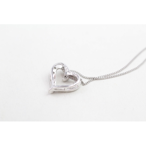 162 - 9ct white gold diamond set floating heart pendant necklace (2.2g)