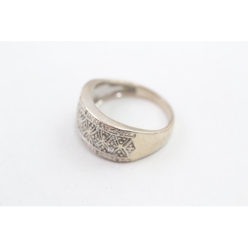 168 - 9ct gold diamond set ornate cut our pattern dress ring (3.1g) Size L