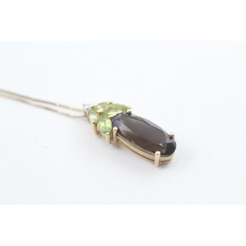 193 - 9ct gold diamond accented peridot and smokey quartz set pendant necklace (3.5g)