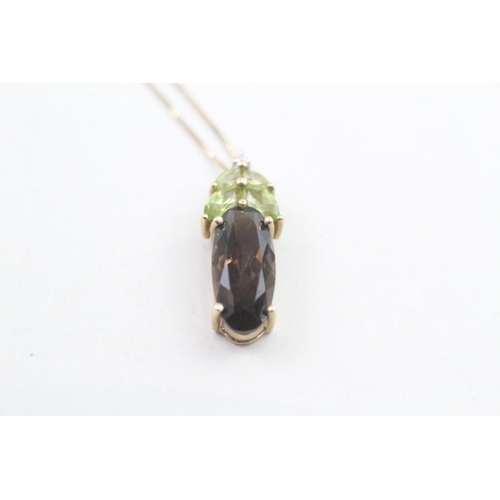 193 - 9ct gold diamond accented peridot and smokey quartz set pendant necklace (3.5g)