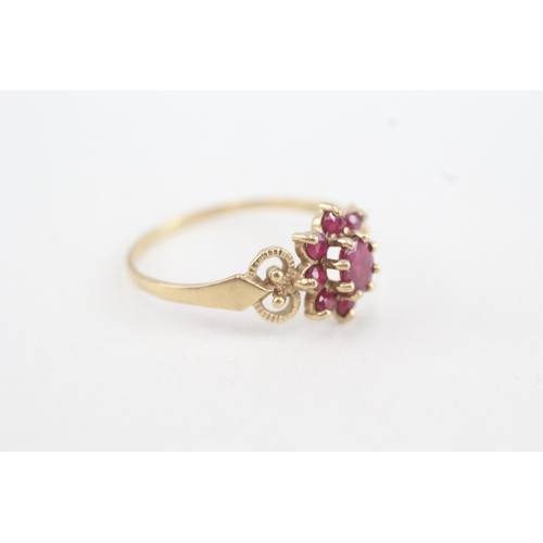 76 - 9ct gold ruby floral cluster ring with openwork shank (1.7g) Size T 1/2