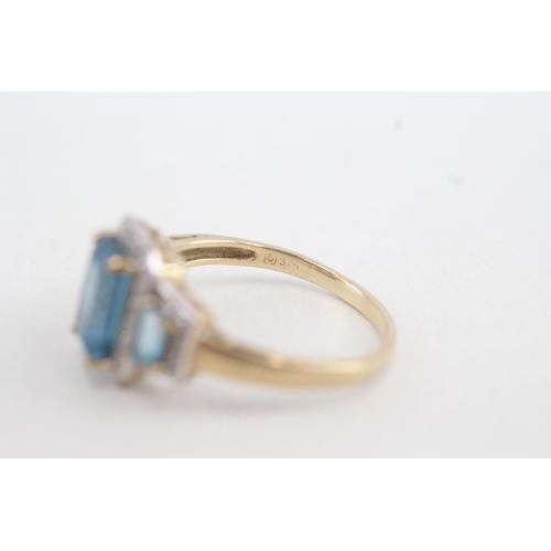 87 - 9ct gold topaz three stone ring with diamond frame (3.3g) Size U 1/2