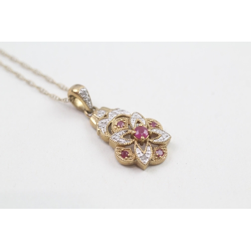 253 - 9ct gold ruby and diamond ornate pave pendant on chain (3g)