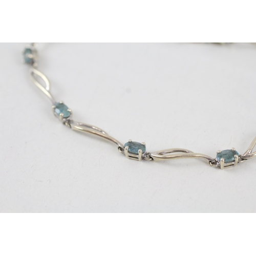 268 - 9ct white gold blue topaz set station necklace (4.2g)