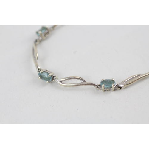 268 - 9ct white gold blue topaz set station necklace (4.2g)