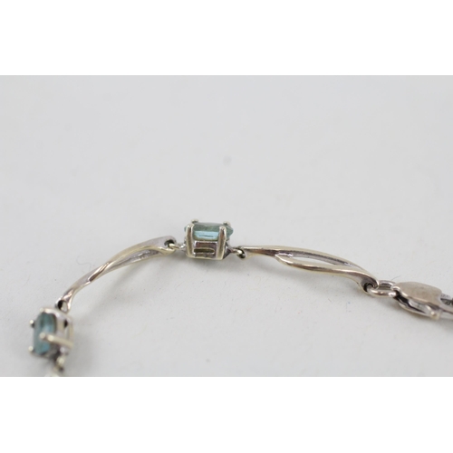 268 - 9ct white gold blue topaz set station necklace (4.2g)