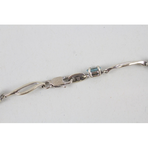 268 - 9ct white gold blue topaz set station necklace (4.2g)