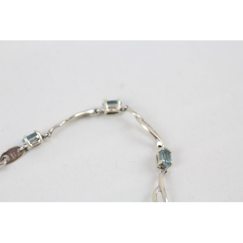 268 - 9ct white gold blue topaz set station necklace (4.2g)