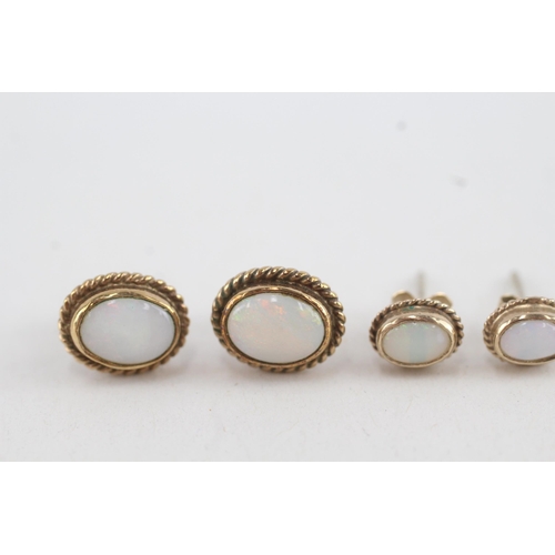 42 - 2x 9ct gold opal stud earrings with scroll backs (2.8g)