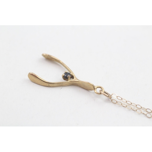 85 - 9ct gold vintage sapphire set wishbone pendant necklace (1.2g)