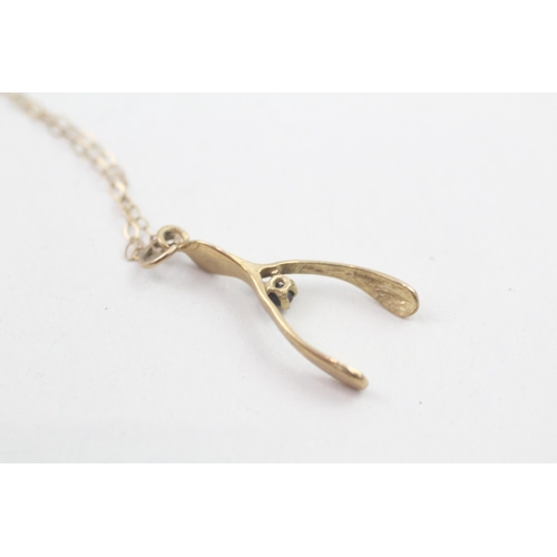 85 - 9ct gold vintage sapphire set wishbone pendant necklace (1.2g)