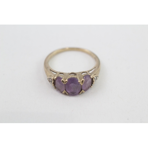 133 - 9ct gold diamond accented amethyst set trilogy ring (2.2g) Size  K