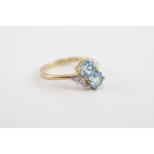 36 - 9ct gold diamond accented blue topaz bypass ring (1.7g) Size  K