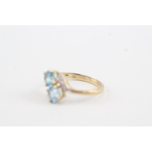 36 - 9ct gold diamond accented blue topaz bypass ring (1.7g) Size  K