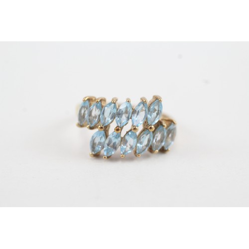 38 - 9ct gold marquise cut blue topaz set wrap ring (2.9g) Size  L