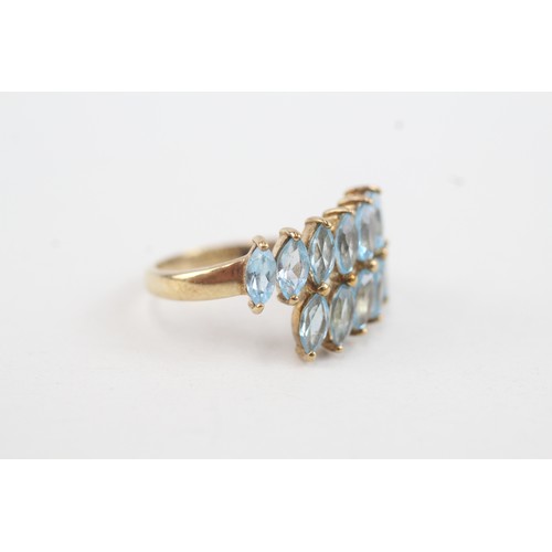 38 - 9ct gold marquise cut blue topaz set wrap ring (2.9g) Size  L