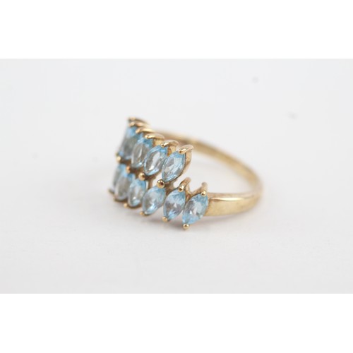 38 - 9ct gold marquise cut blue topaz set wrap ring (2.9g) Size  L