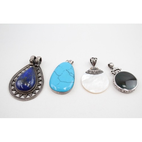 Four silver gemstone pendants including Lapis Lazuli (61g)