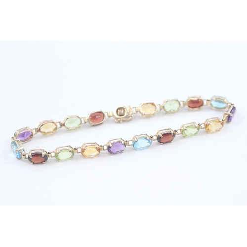 10 - 9ct gold multi-gemstone line bracelet, gemstone including amethyst, citrine, blue topaz (6.7g)