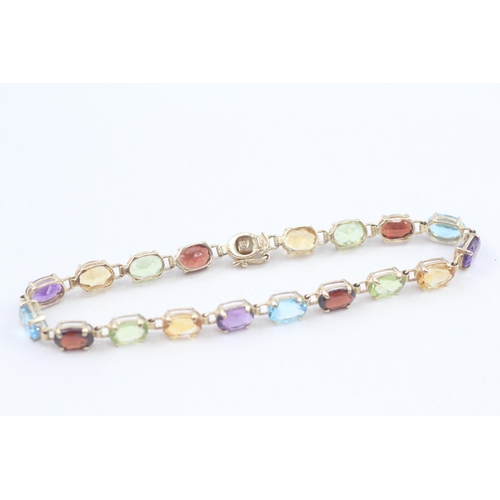 10 - 9ct gold multi-gemstone line bracelet, gemstone including amethyst, citrine, blue topaz (6.7g)