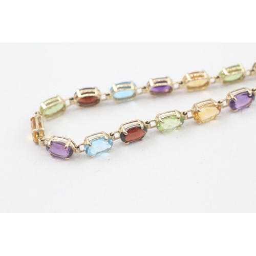 10 - 9ct gold multi-gemstone line bracelet, gemstone including amethyst, citrine, blue topaz (6.7g)