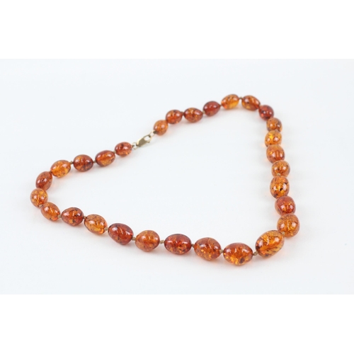 110 - 9ct gold clasped Baltic amber graduated bead necklace (44.3g)