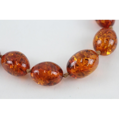 110 - 9ct gold clasped Baltic amber graduated bead necklace (44.3g)