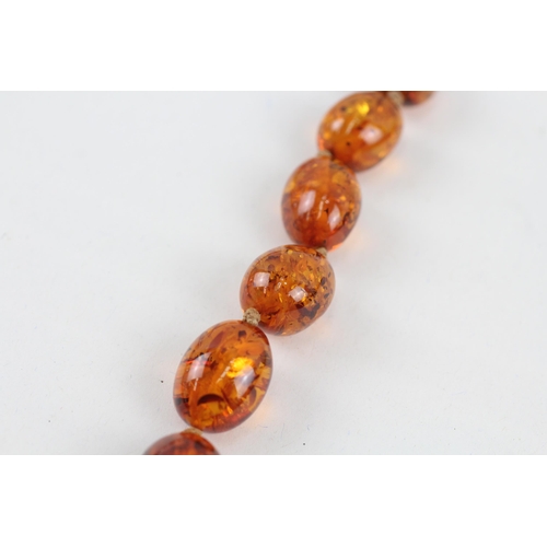 110 - 9ct gold clasped Baltic amber graduated bead necklace (44.3g)