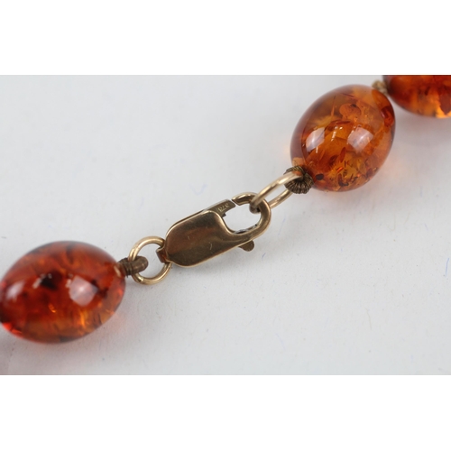 110 - 9ct gold clasped Baltic amber graduated bead necklace (44.3g)