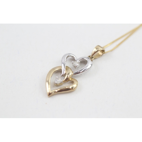 114 - 9ct gold white and yellow gold diamond set double hearts pendant necklace (2.3g)