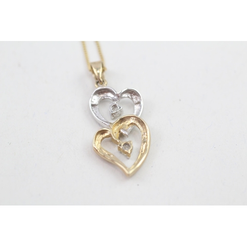 114 - 9ct gold white and yellow gold diamond set double hearts pendant necklace (2.3g)