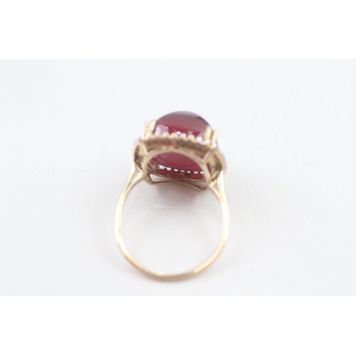 57 - 9ct gold diamond accented sugarloaf cut garnet cocktail ring (6.3g) Size  M 1/2