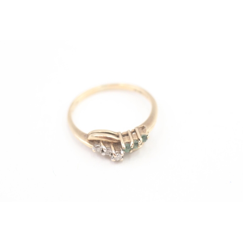 70 - 9ct gold diamond and emerald bypass wave band ring (2g) Size  P