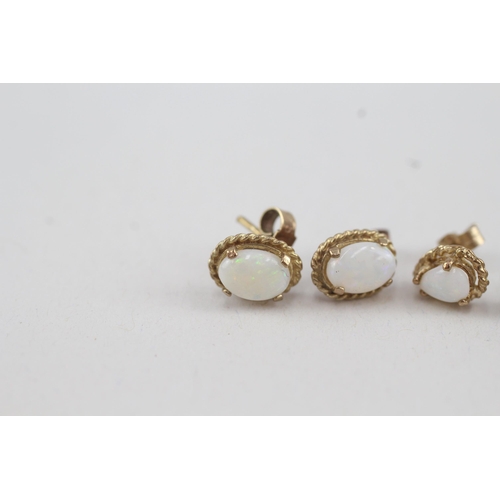 79 - 2x 9ct gold opal stud earrings with scroll backs (2.1g)