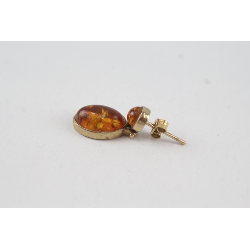 47 - 9ct gold cabochon cut amber drop earrings with scroll backs (2.6g)