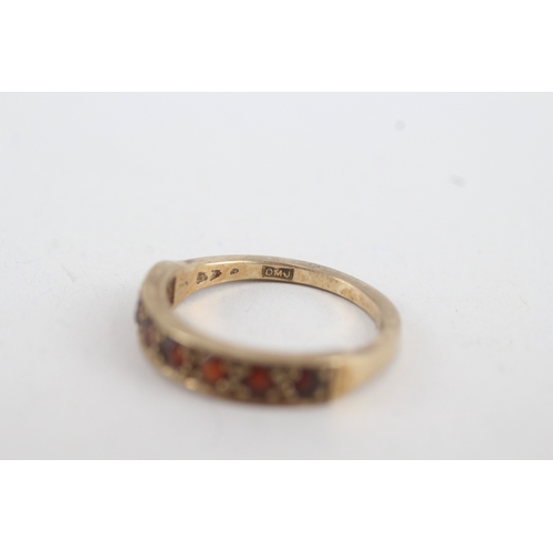 111 - 9ct gold garnet seven stone ring (2.5g) Size  N